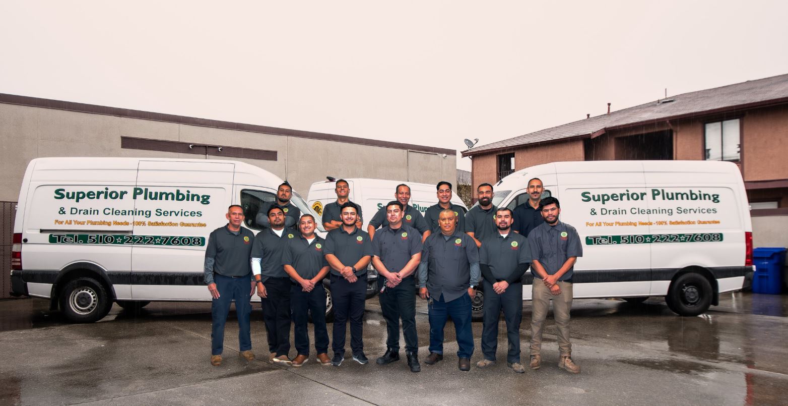 Works in front of Van Superior Plumbing team in front of van